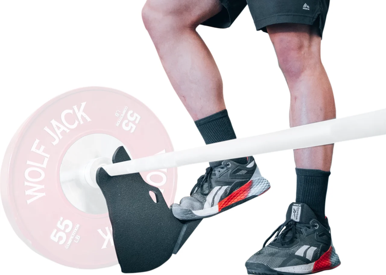 Foot-operated Wolf Jack lifting a loaded barbell for a plate change